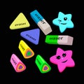 Colored erasers of different shapes on a black background.